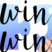 Hand writing the words 'win win' with a black marker. There is a blue and white background.